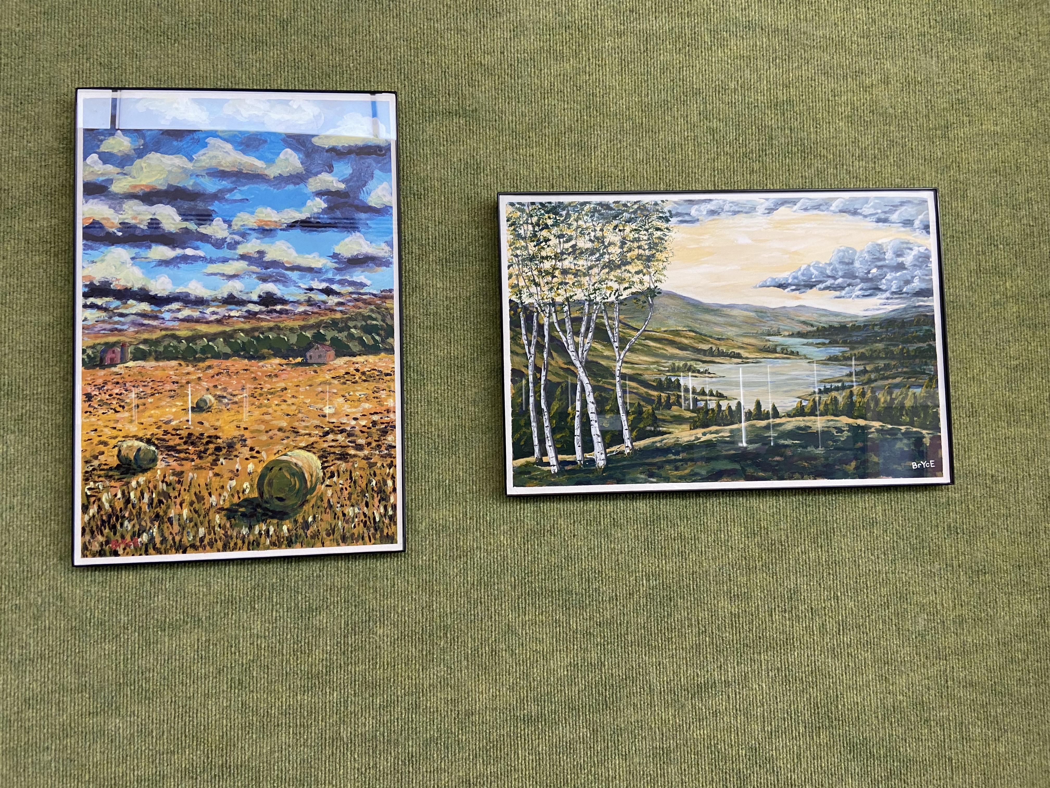 green textured background with framed landscape paintings