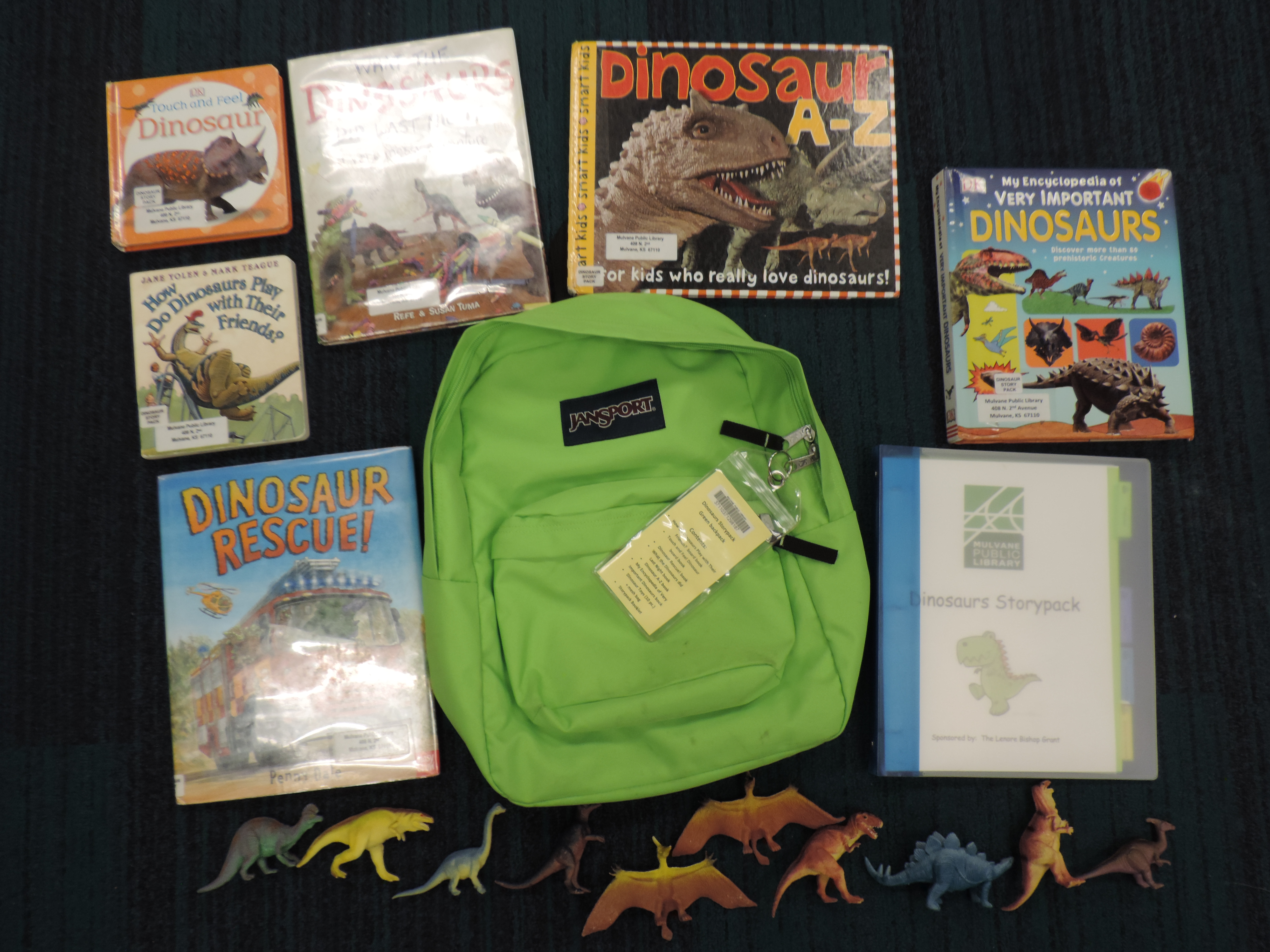 Green backpack with books and activities