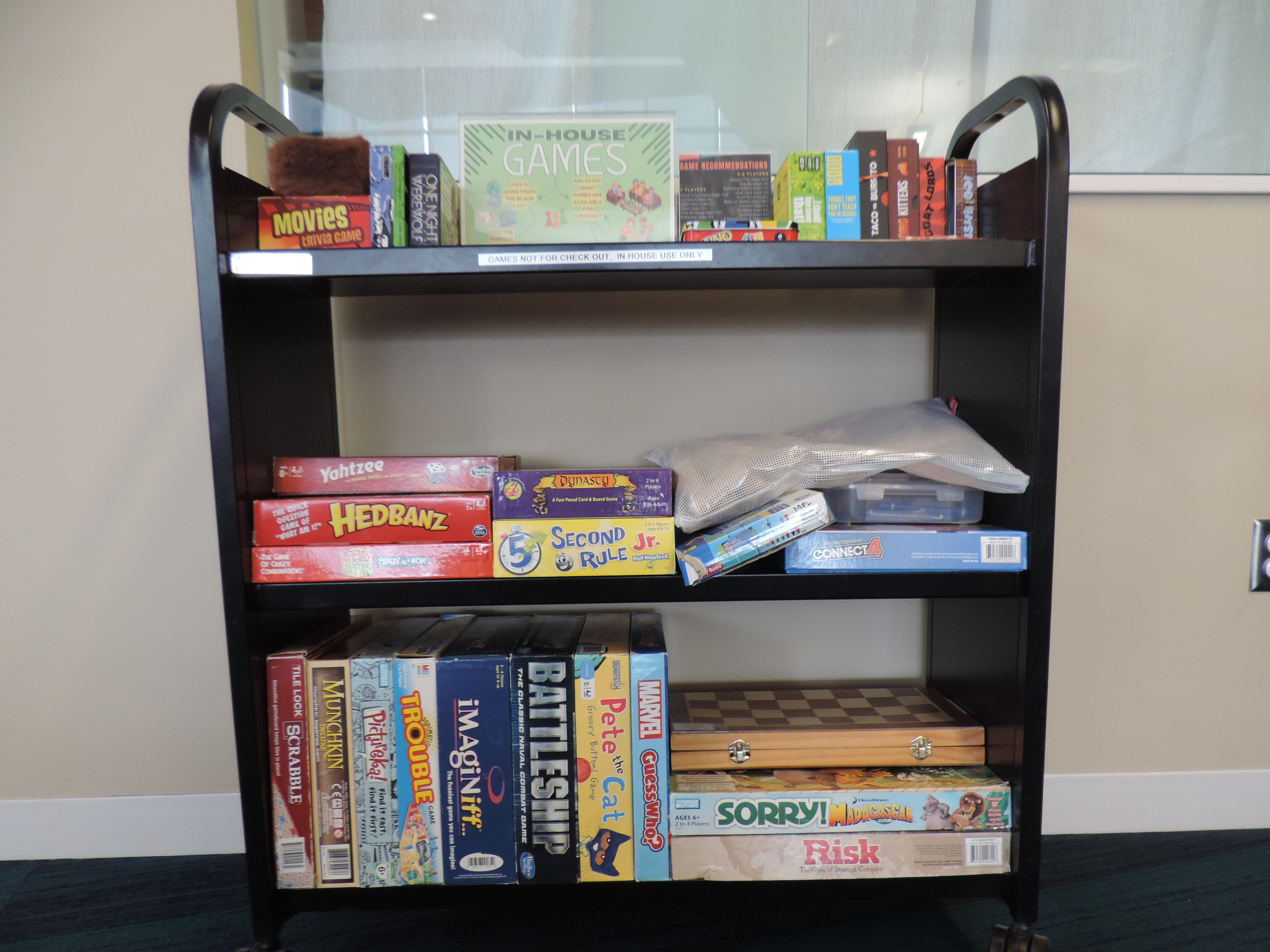 Black cart with various board games