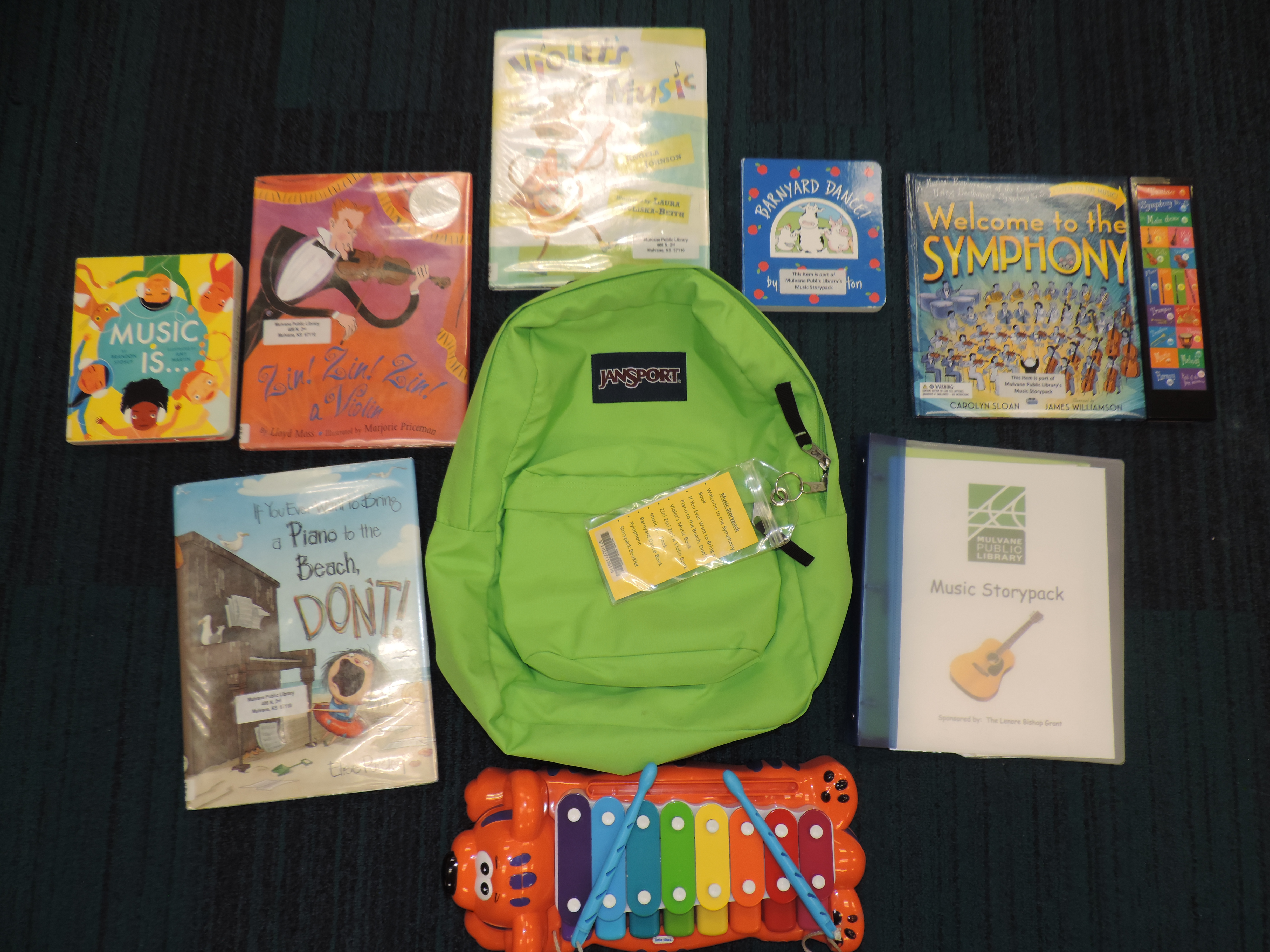 Green backpack with books and activities