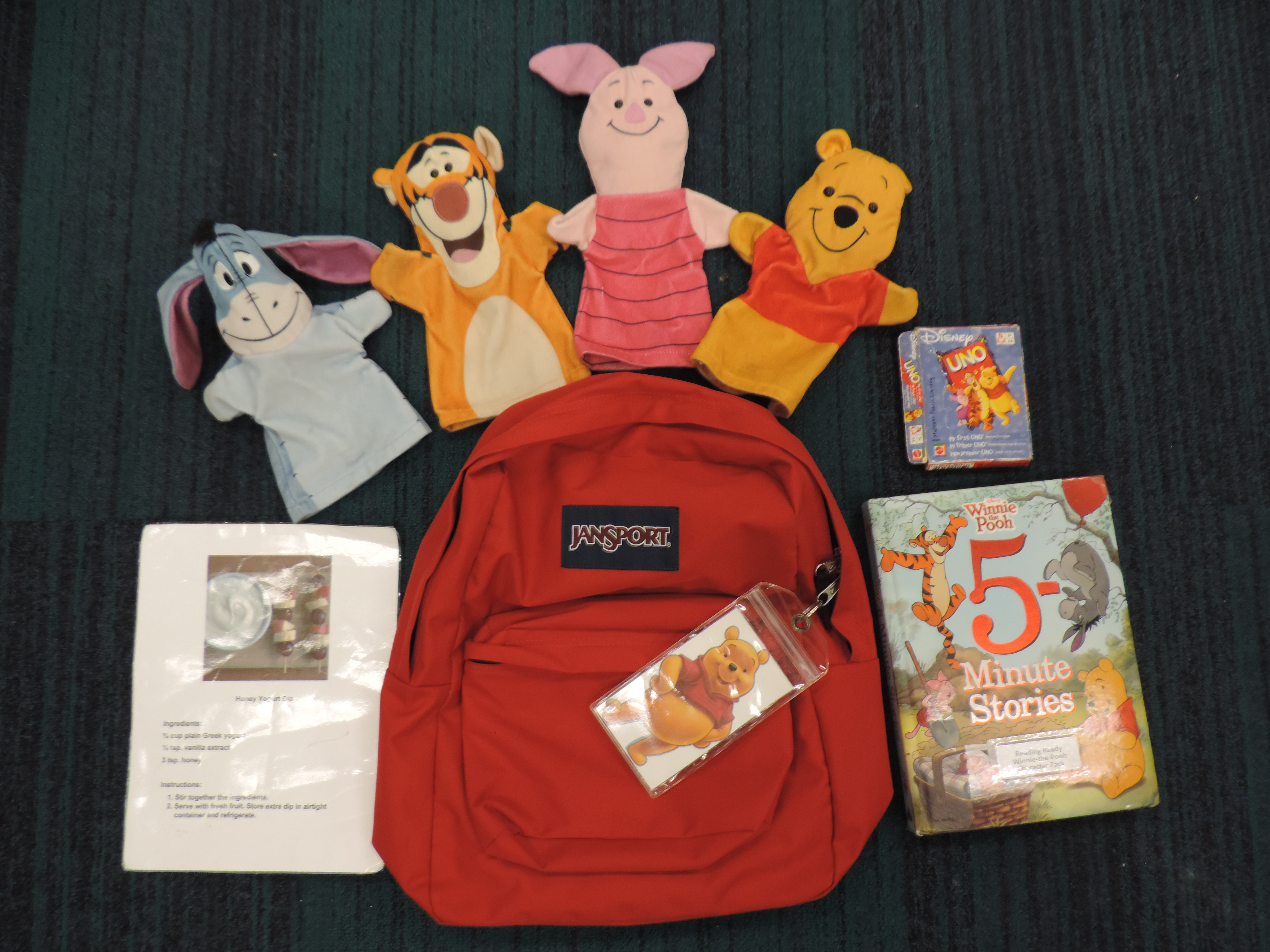 Red backpack with books, activities and 5 character puppets