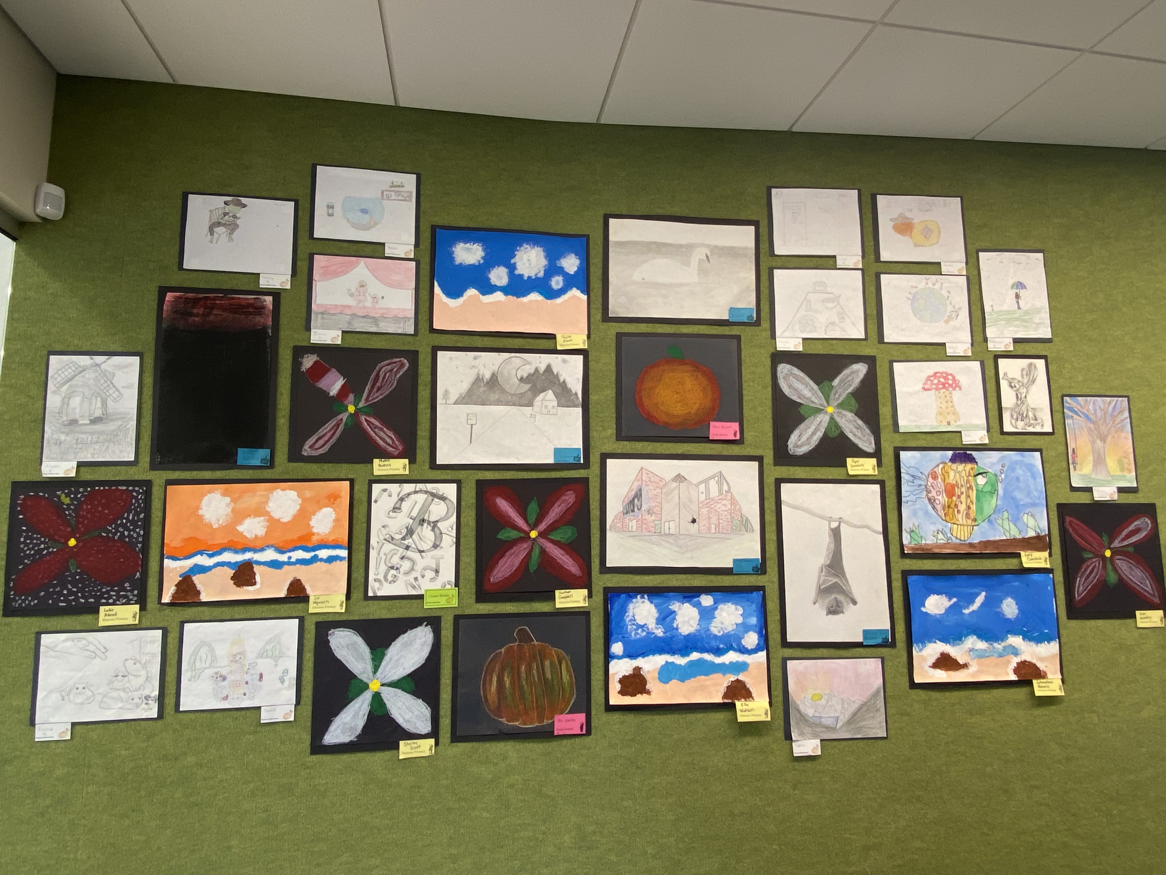 variety of art on green wall