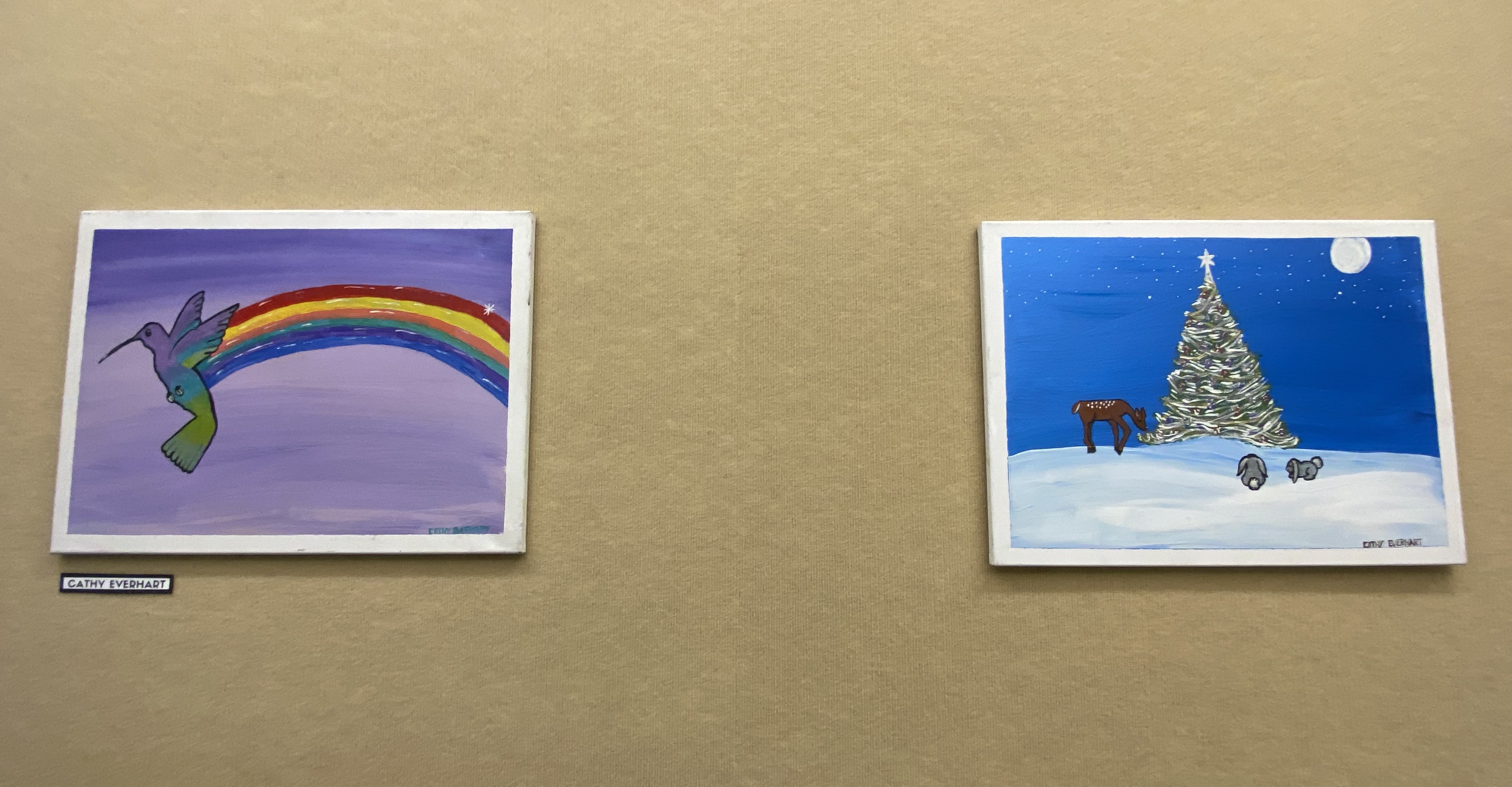 two paintings on beige wall