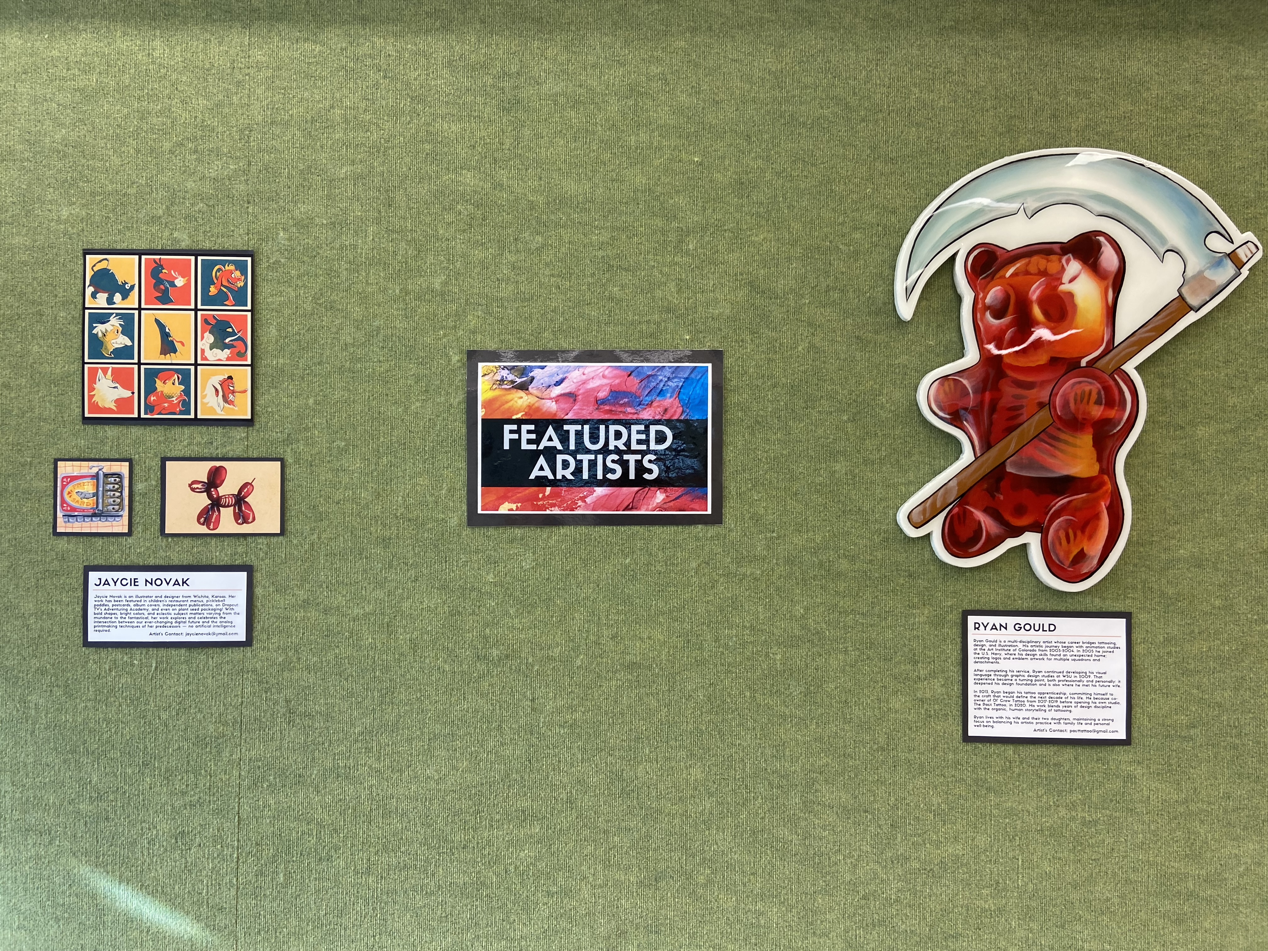 cluster of small drawings and a large gummy bear sculpture on green background