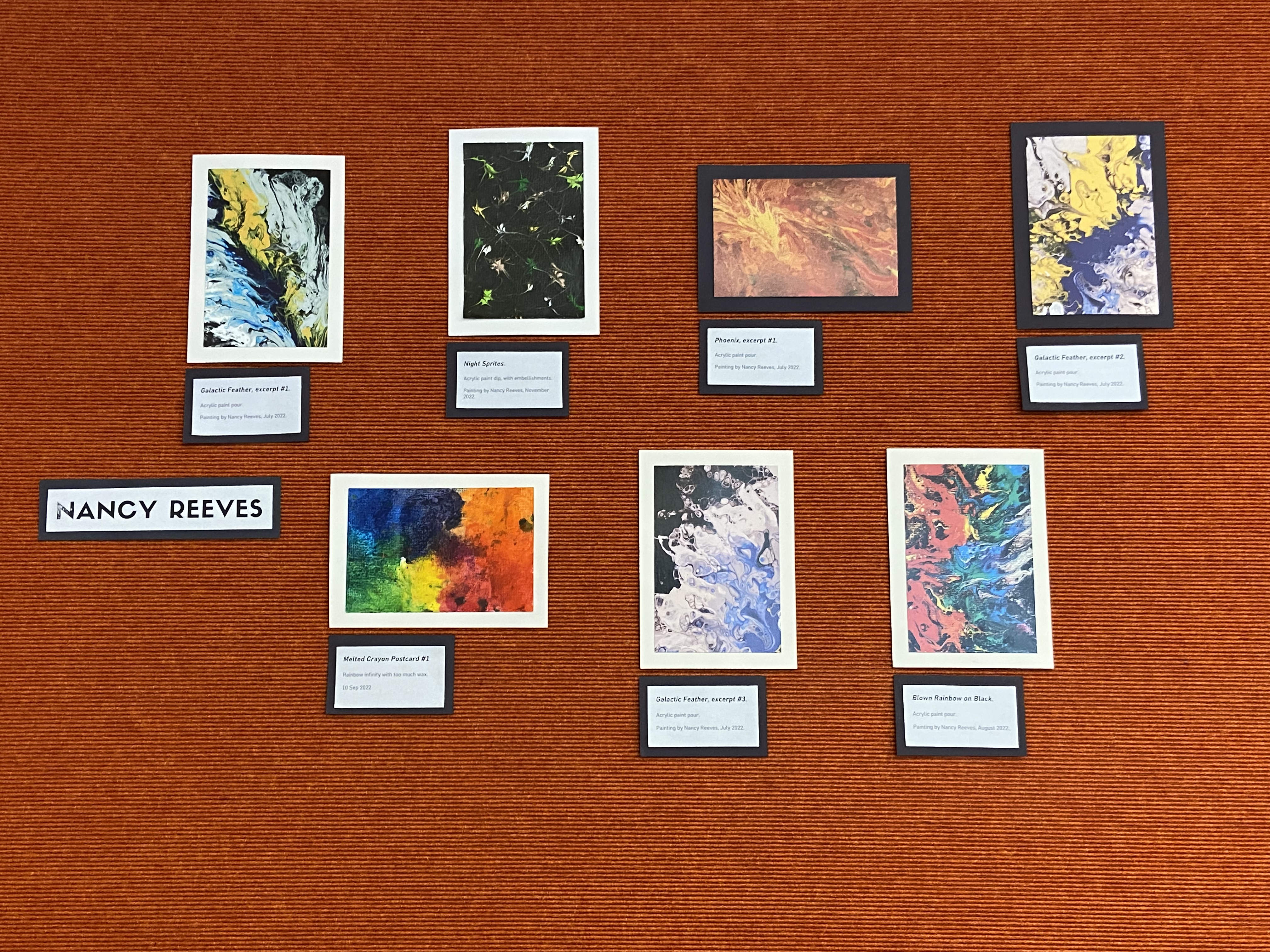 postcards on orange textured wall