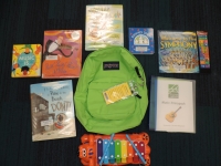 Green backpack with books and activities