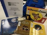 Blue backpack with books and museum pass