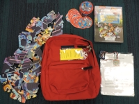 Red backpack with books and activities, puzzle pieces 