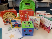 Green backpack with books and activities