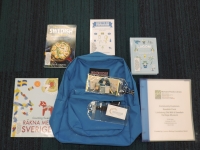 Blue backpack with books and museum pass