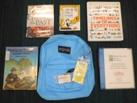 Blue backpack with books and museum pass