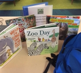 Blue backpack with books and museum pass