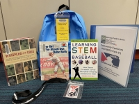 Blue backpack with books and baseball pass
