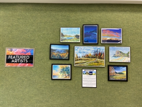 Tye-Dye Featured Artist sign with circle of paintings 